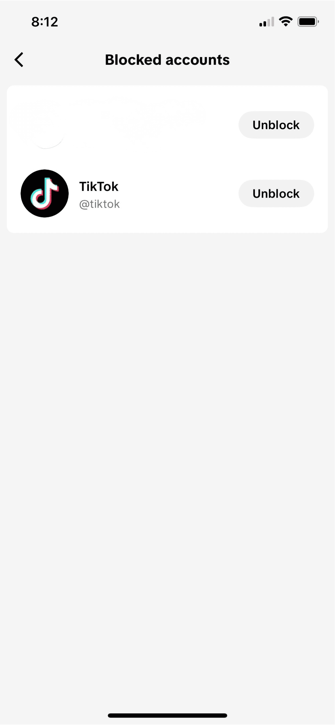 TikTok Blocked accounts screen on mobile showing TikTok account with Unblock button visible.
